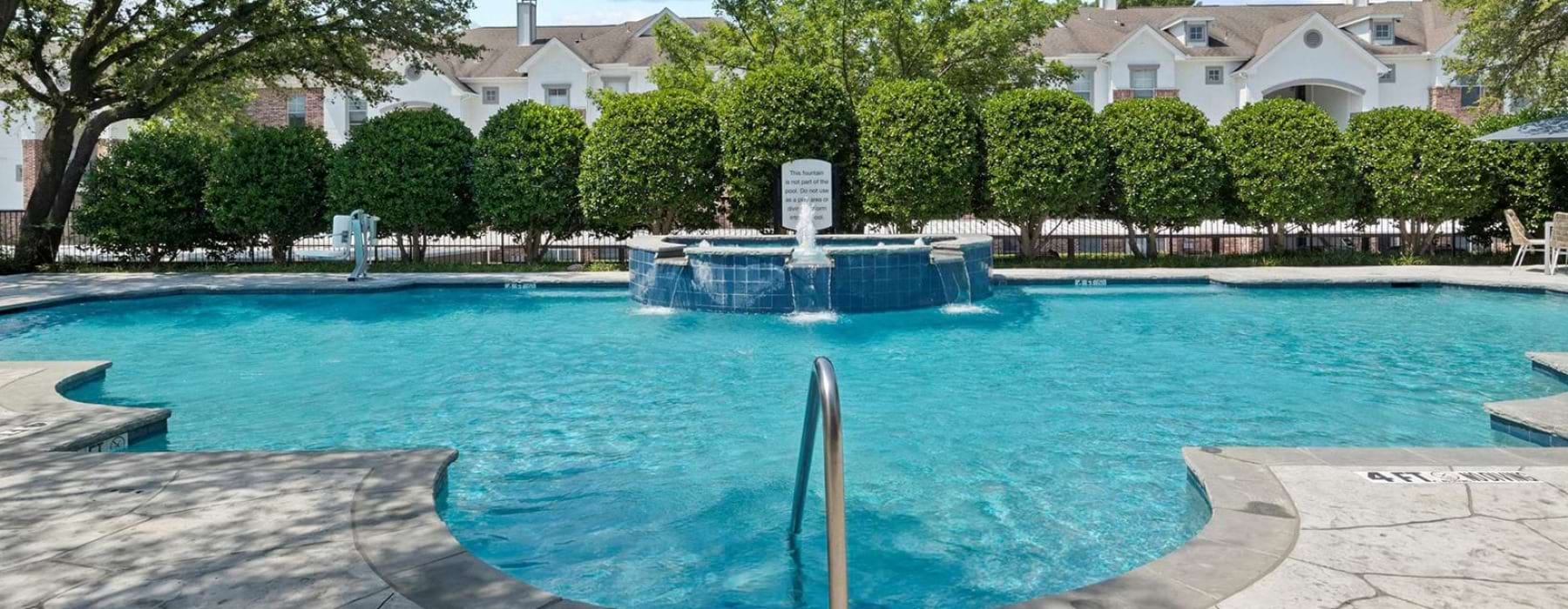 Spacious sparkling pool with sundecks and cabanas for lounging.