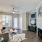 Model living room at our apartments in Flower Mound, featuring wood grain floor paneling and a fireplace.