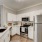 Model kitchen at our apartments for rent in Flower Mound, TX, featuring white countertops and stainless steel appliances.