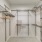 Walk in closet at our apartments for rent in Flower Mound, featuring racks, hangers and white walls.