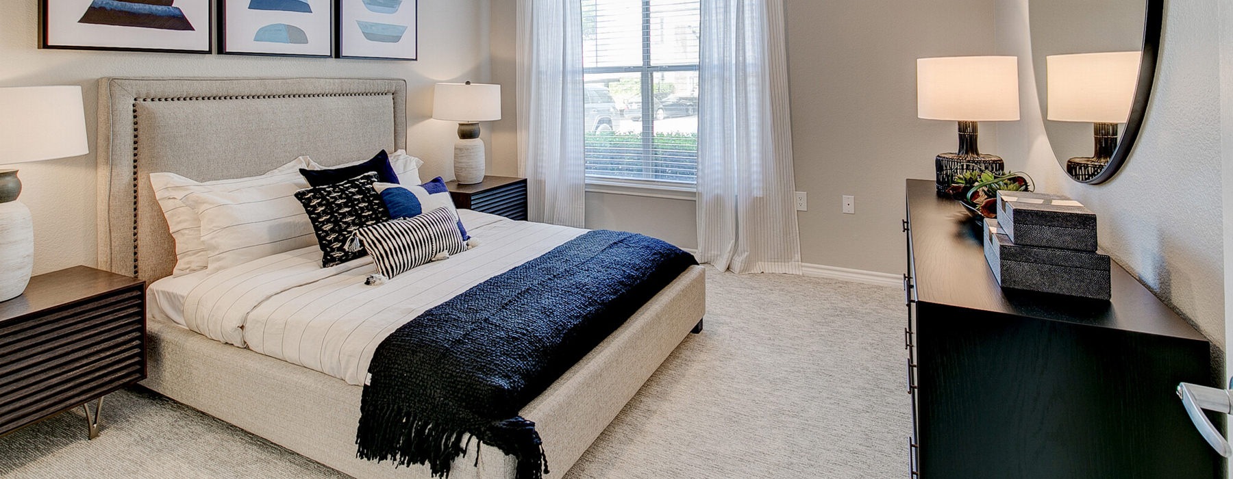 Bedroom with large bed, ensuite. queen bed and nightstands.